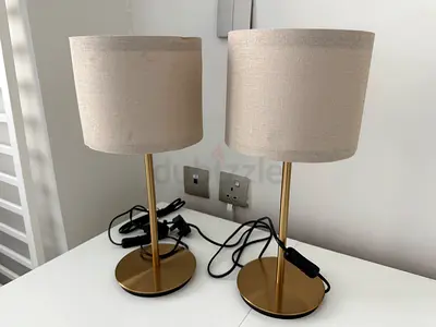 Pair of modern gold table lamps with beige fabric shades