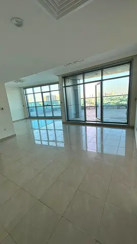 Two-bedroom apartment with a living room in Corniche Residence towers, city view.