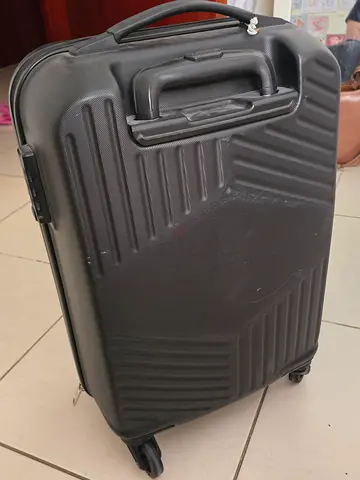 American Tourister Black hard-shell 4-wheel carry-on suitcase (used)