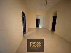 Two-bedroom apartment with a living room, two bathrooms, and a balcony, located in Al Jurf 2, close