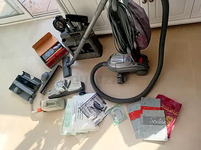 Kirby vacuum cleaner with multiple attachments and bags