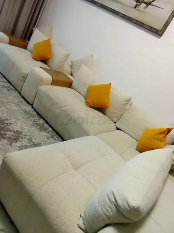 6 seater FEATHER sofa , beige color no damage . 1 year for 1k AED only