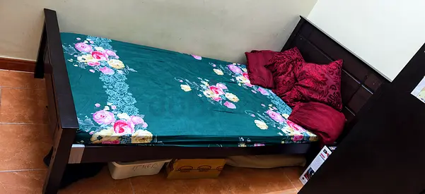 Single wooden bed frame with mattress and headboard