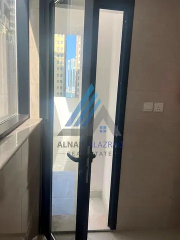 Apartment for Rent: A Distinctive One-Bedroom Apartment with a Living Hall and Balcony in the Al Taawun Area, Located Directly on the Dubai Exit withi