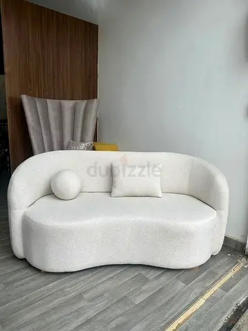 Cream Two-Seater Curved Sofa with Cushions