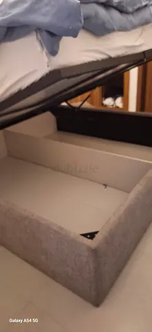 Grey upholstered bed frame with storage base (single/king single look) - good condition