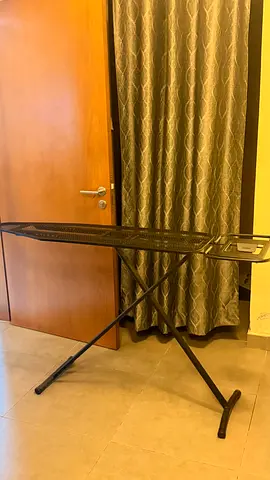 Sturdy foldable ironing board with iron rest