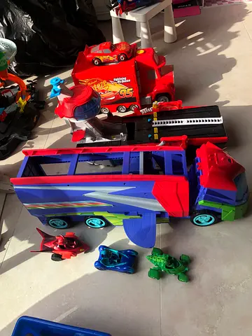Large toy truck with multiple small ride-on cars - used set