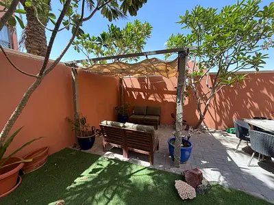 Outdoor wooden pergola with seating set and shade sail