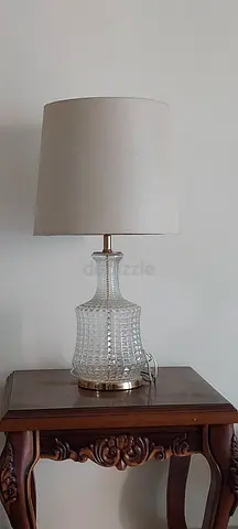 Glass Table Lamp with Beige Fabric Shade on Wooden Side Table