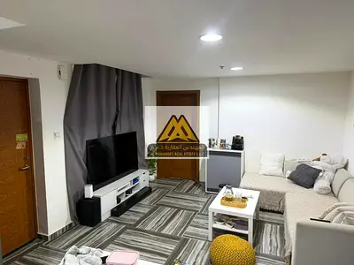 A 1-bedroom apartment with a living room available for monthly or annual rent in Al Rashidiya 3 – Ajman, located in Aida Tower. The apartment is brand