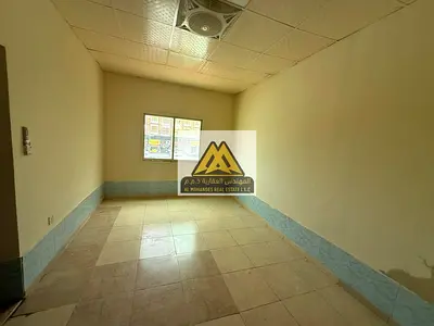 A spacious studio for annual rent in Al Mowaihat 3 – Ajman, featuring a separate kitchen and split air conditioning in a prime location close to all s
