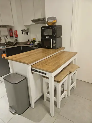 Compact kitchen island with sliding breakfast bar and two stools