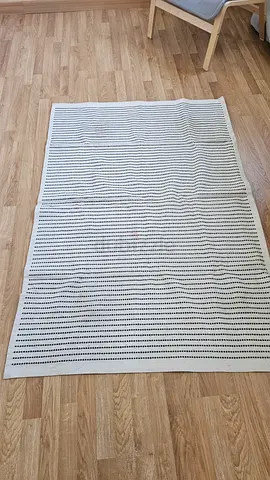 Light beige rectangular rug with dotted pattern
