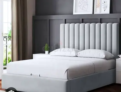 Grey upholstered double bed with padded vertical channel headboard - excellent condition
