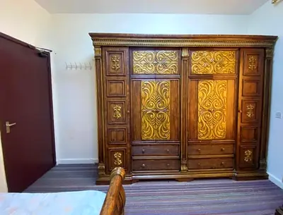 Luxury wooden bedroom set for sale. Includes a king size bed, large wardrobe, dressing table
