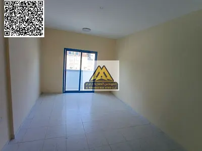 A spacious 1-bedroom apartment with a separate living room for annual rent in Al Hamidiya 1 – Ajman, featuring a balcony and central air conditioning