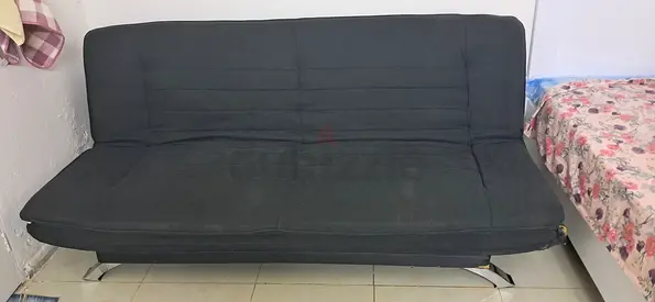 Used black fabric futon sofa bed with chrome legs - good condition