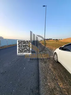 Prime commercial land available for sale in Al Helio 2, strategically located on a main road with ex
