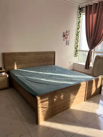 Queen-size wooden bed frame with headboard and footboard - good condition