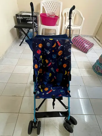 Lightweight umbrella stroller with space-themed fabric — good condition