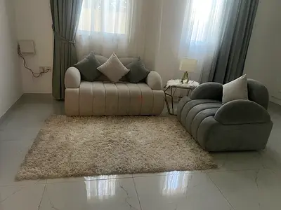 Pair of modern lounge sofas with shaggy area rug - light neutral set