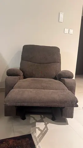 Used grey fabric reclining armchair in good condition