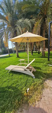 Rattan Outdoor Sun Lounger with Umbrella and table in Good Condition