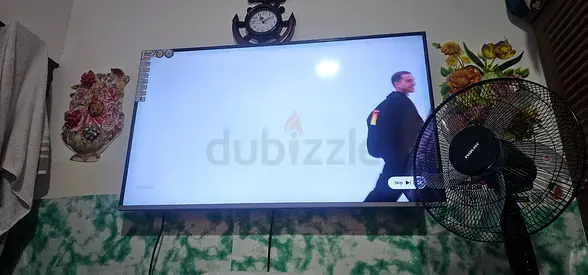 55-inch LED TV in good working condition, wall-mounted