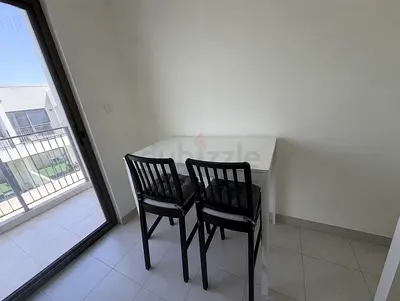 Compact white dining table with two black chairs - good condition