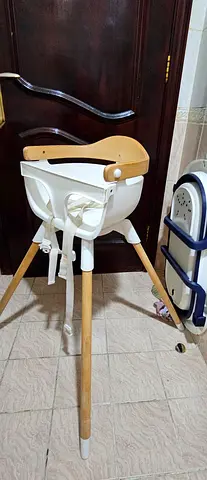 Wooden-legged baby high chair with safety straps - good condition