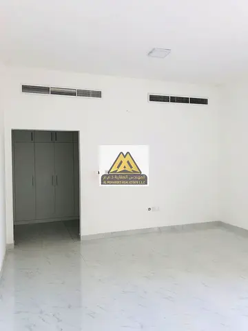 A spacious 1-bedroom apartment with a living room for annual rent in Al Hiliou 2 – Ajman, featuring