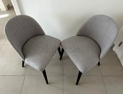 Pair of light grey upholstered dining/accents chairs with wooden legs