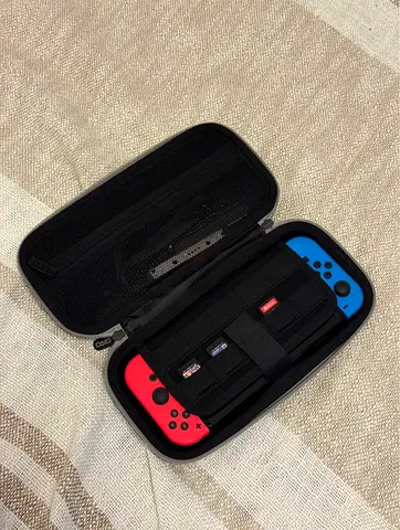 Nintendo Switch (Neon) with Travel Carry Case and 3 games