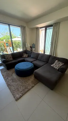 L-shaped dark grey fabric corner sofa with chaise