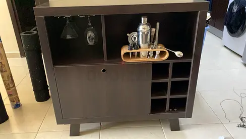Compact dark wood bar cabinet with rack and storage