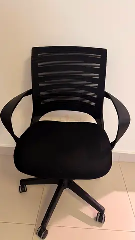 Black ergonomic office chair with mesh back and armrests