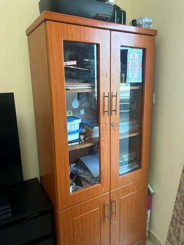 Tall wooden display cabinet with glass doors - good condition