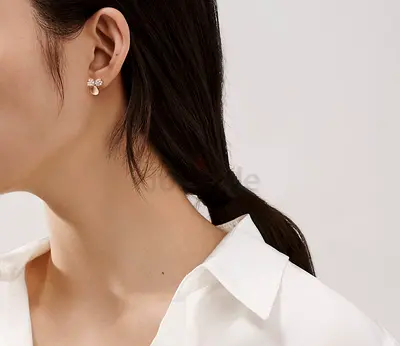 Tiffany Co Delicate paper flower stud earrings with diamonds.