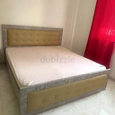 King-size bed frame with padded headboard and footboard - good condition
