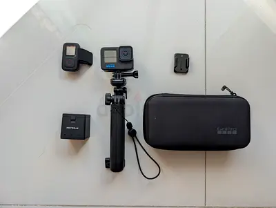 GoPro HERO 11 action camera with accessories (case, 3 batteries, remote control, mount, grip)