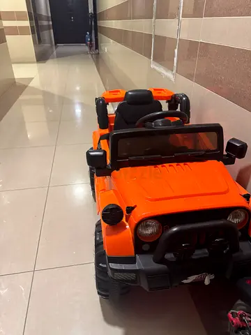 Electric ride-on toy car (orange) - good working condition