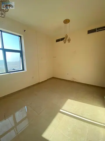 A two-bedroom apartment with a living room is available for annual rent in Al Jurf Industrial Area 3, Ajman, behind the Chinese Market and close to th
