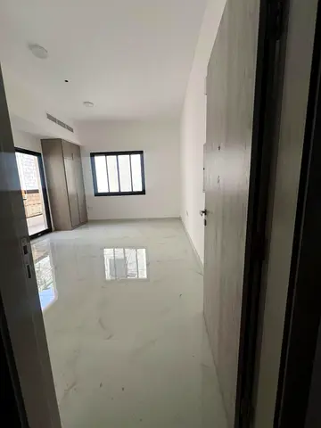 Brand new studio for yearly rent in Al Alia Ajman, semi separate kitchen, balcony, built-in wardrobes, central AC, prime location with easy access to