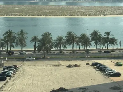 Luxury two-bedroom apartment with a living room in Al Khan, Sharjah, available for annual rent - very large balcony - built-in wardrobes - practical k