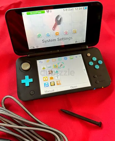 Nintendo 2DS XL (Aqua + Black) handheld console with stylus and charger cable
