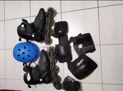 Inline roller skates with helmet and protective pads - size likely adult
