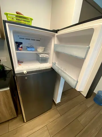 Compact stainless steel refrigerator with small freezer, good condition