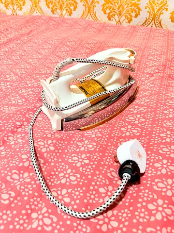 Lightly used clothes iron with braided cord
