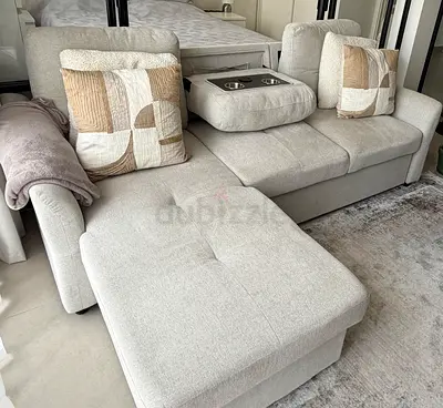 Storage and sofa bed- Light grey fabric L-shaped sofa with ottoman and cup holder